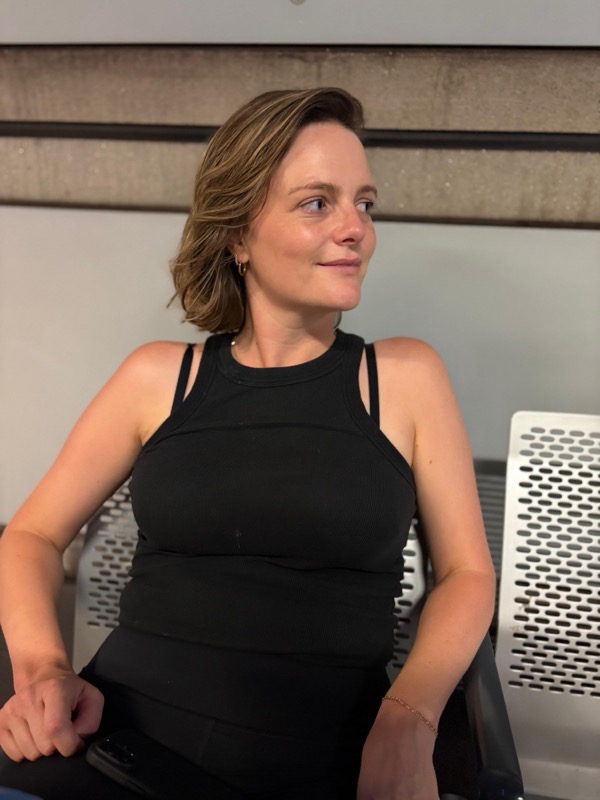 Frances, smiling and looking to the side
